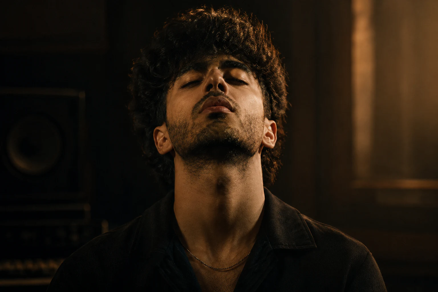 An intimate close-up portrait of Ashie Keys in a warmly lit studio